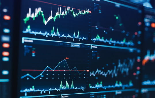 Multiple screens displaying diverse data sets for efficient market access and risk management with StoneX Pro