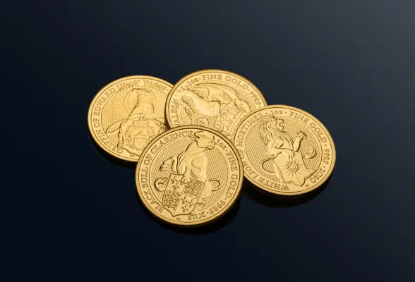 Four gold coins arranged on a black background, shining brightly, representing StoneX Bullion services