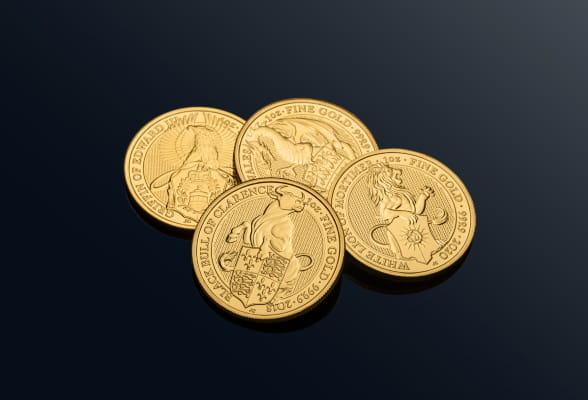 Four gold coins arranged on a black background, shining brightly, representing StoneX Bullion services