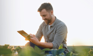 Trader in the field using a tablet for physical trading