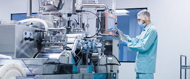 Technician operating machinery in a high-tech cotton processing facility, supporting global trade and finance.