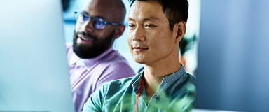 Professionals in conversation representing StoneX’s culture of transparency and regulatory compliance.