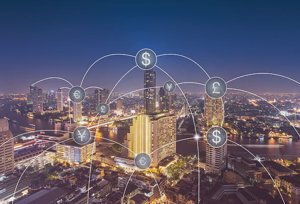 City skyline at night with currency symbols connected by digital lines, representing StoneX’s global Swift infrastructure services including remote management, dedicated hosting, and service bureau support.
