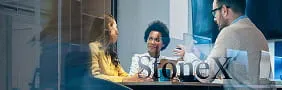 Financial professionals in a meeting at StoneX, representing capital markets services for sourcing capital and financial solutions.