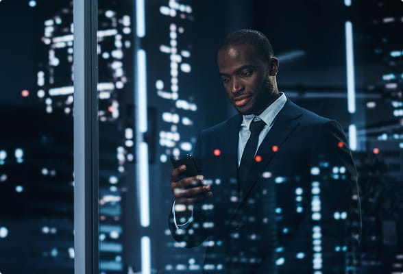 Financial professional reviewing crypto market data on a mobile device, representing StoneX Digital's institutional lending solutions.