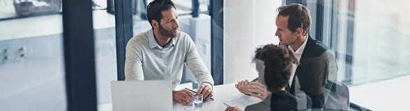 Financial professionals in a meeting, representing StoneX Digital’s tailored digital asset management solutions for family offices.