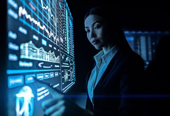 Trader analyzing market data on multiple screens, representing institutional liquidity and FX solutions for proprietary trading firms.