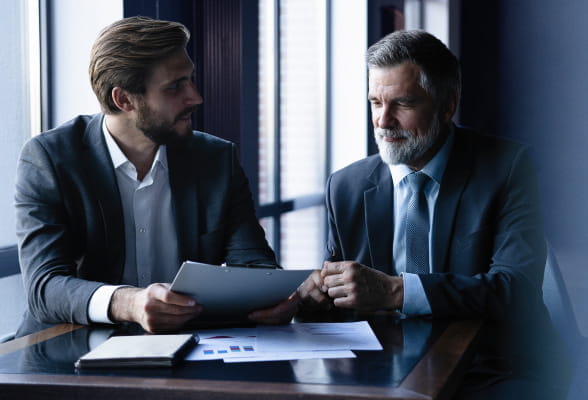 Two men in discussion, emphasizing StoneX Wealth Management's mission to provide tailored support and resources to meet financial goals