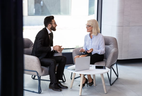 Two people discussing estate planning, representing StoneX Wealth Management's wealth transfer and fiduciary services