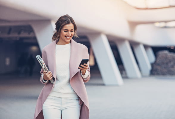 Woman using a smartphone, representing StoneX Wealth Management's strategic financial planning services for every stage of life