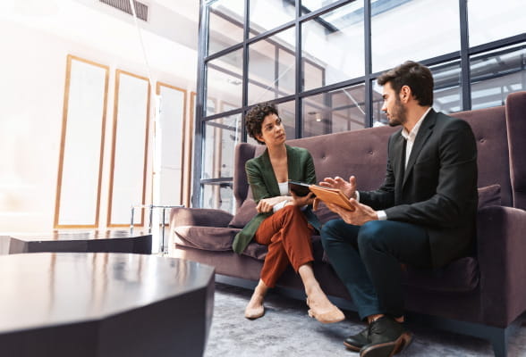 Two professionals discussing investment strategies, highlighting StoneX Wealth Management's custom advisory solutions for financial advisors